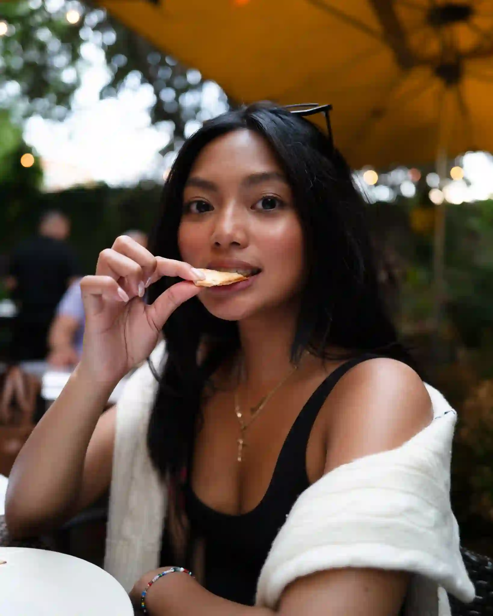 Guest tasting a crisp on the Piccolo Sogno patio