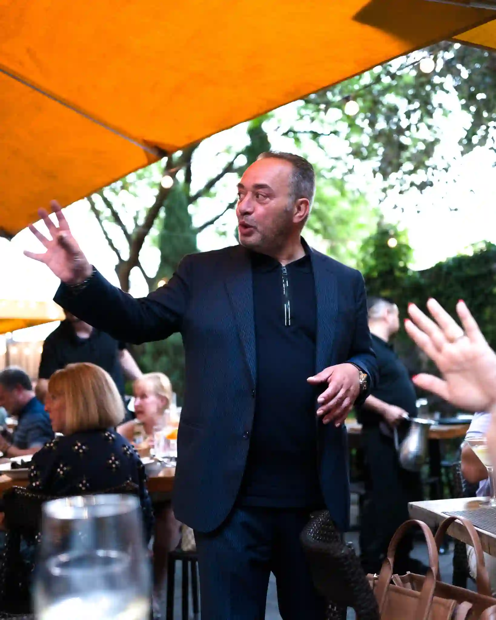 Host greeting guests on the Piccolo Sogno patio