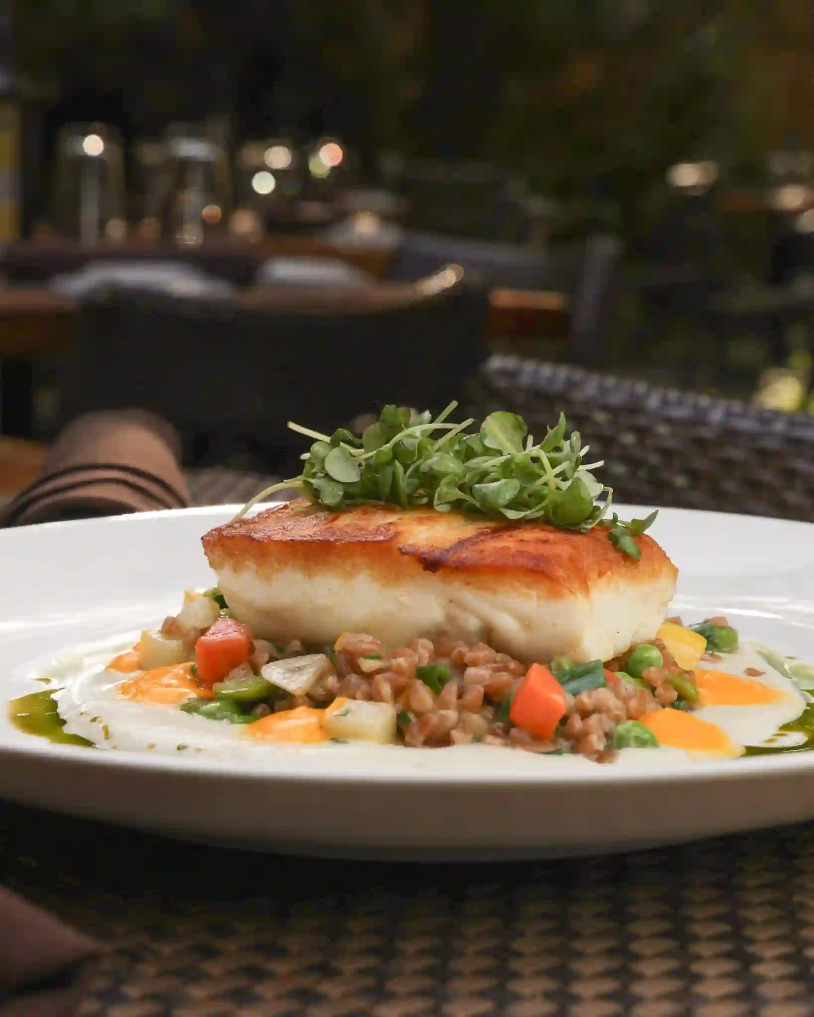 Seared halibut over farro and spring vegetables
