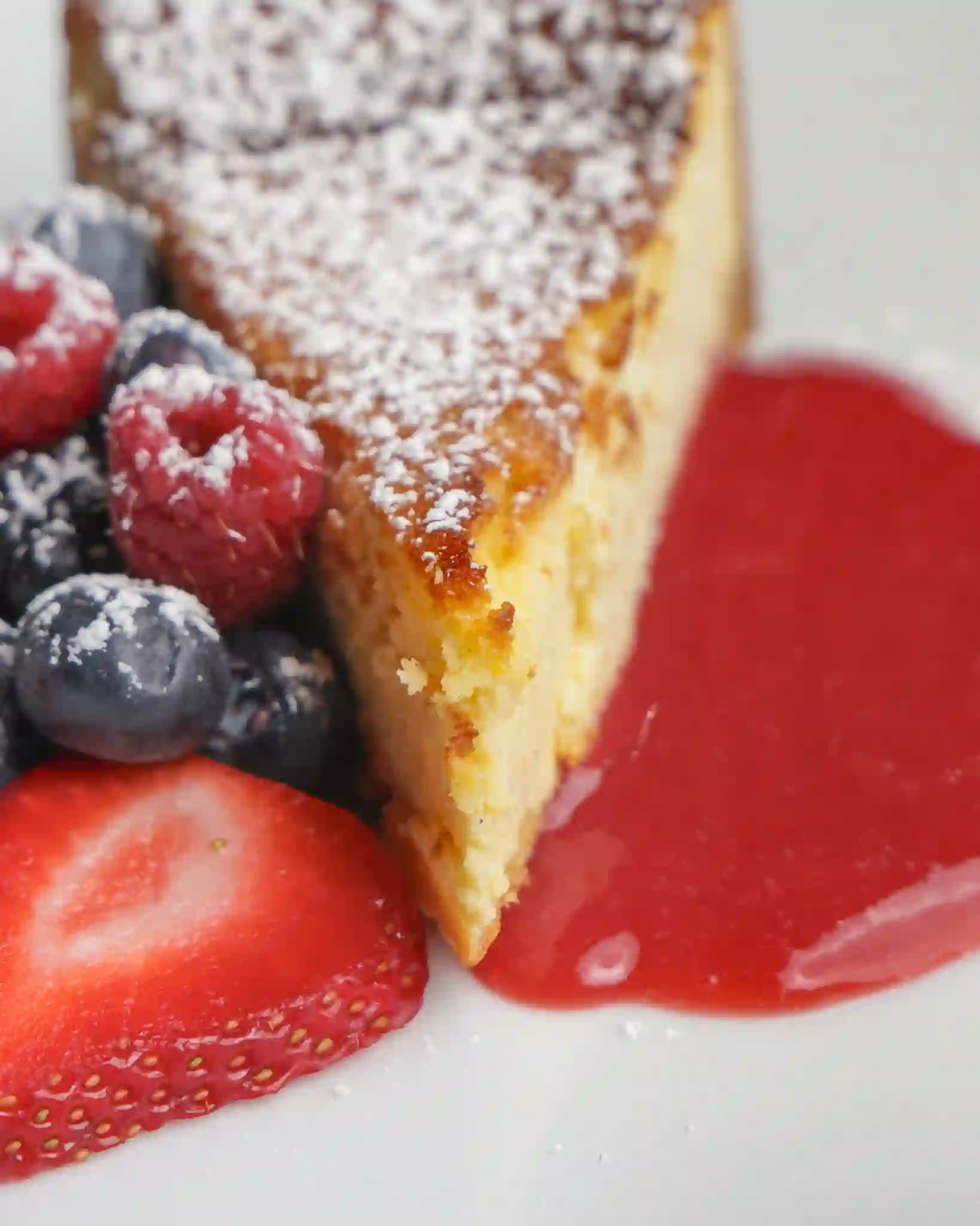 Olive oil cake with berries and strawberry sauce